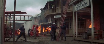 Movie still from “The Hawaiians” (1970), directed by Tom Gries – A group of people standing next to a fire; Wide shot, Low angle