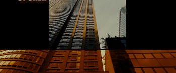 Movie still from “The Heat” (2013), directed by Paul Feig – A tall building with many windows in a city; Extreme Wide shot, Low angle