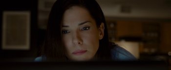 Movie still from “The Heat” (2013), directed by Paul Feig – A person sitting in front of a computer; Close Up shot, High angle