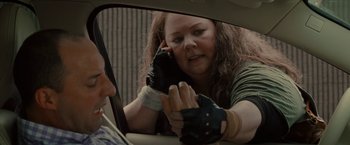 Movie still from “The Heat” (2013), directed by Paul Feig – A woman is talking on a cell phone in a car; Close Up shot, Over the shoulder angle