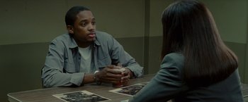 Movie still from “The Heat” (2013), directed by Paul Feig – A man and a woman are sitting at a table talking; Medium shot, Over the shoulder angle