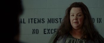 Movie still from “The Heat” (2013), directed by Paul Feig – A woman standing in front of a brick wall; Close Up shot, Over the shoulder angle