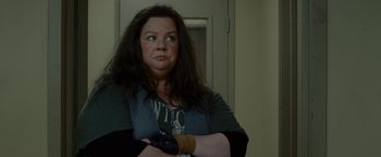 Movie still from “The Heat” (2013), directed by Paul Feig – A woman standing with her arms crossed in front of a door; Close Up shot, Over the shoulder angle