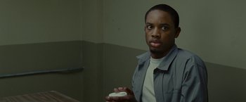 Movie still from “The Heat” (2013), directed by Paul Feig – A man holding a remote control in his hand; Close Up shot, Over the shoulder angle