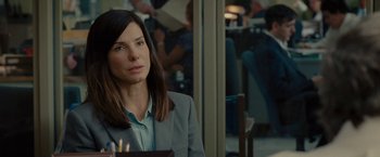 Movie still from “The Heat” (2013), directed by Paul Feig – A woman sitting at a table in front of a window; Close Up shot, Over the shoulder angle
