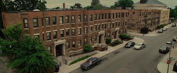 Movie still from “The Heat” (2013), directed by Paul Feig – An old car parked on the side of the street; Extreme Wide shot, High angle