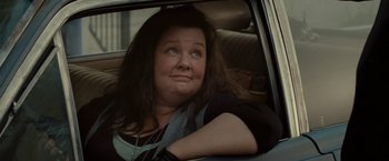Movie still from “The Heat” (2013), directed by Paul Feig – A woman sitting in the back seat of a car; Close Up shot, Low angle