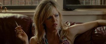 Movie still from “The Heat” (2013), directed by Paul Feig – A woman sitting on top of a couch looking at the camera; Close Up shot, Over the shoulder angle