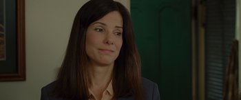 Movie still from “The Heat” (2013), directed by Paul Feig – A person wearing a suit and tie; Close Up shot, Over the shoulder angle