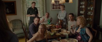 Movie still from “The Heat” (2013), directed by Paul Feig – A group of people sitting around a table with food on top of it; Medium shot, High angle