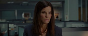 Movie still from “The Heat” (2013), directed by Paul Feig – A woman with long hair wearing a suit; Close Up shot, Over the shoulder angle