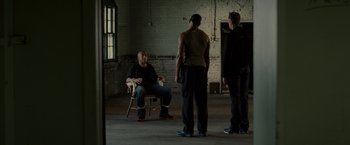 Movie still from “The Heat” (2013), directed by Paul Feig – A group of men standing in a room; Wide shot, High angle