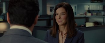 Movie still from “The Heat” (2013), directed by Paul Feig – A woman in a suit and a man in a suit; Close Up shot, Over the shoulder angle