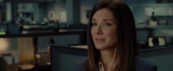 Movie still from “The Heat” (2013), directed by Paul Feig – A woman with long hair is looking to her left; Close Up shot, Over the shoulder angle