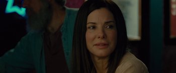 Movie still from “The Heat” (2013), directed by Paul Feig – A person with long black hair; Close Up shot, Over the shoulder angle