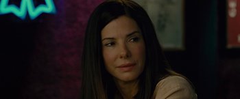 Movie still from “The Heat” (2013), directed by Paul Feig – A person with long black hair; Close Up shot, Over the shoulder angle