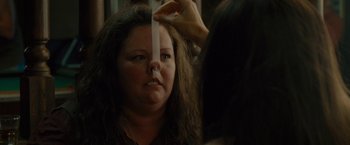Movie still from “The Heat” (2013), directed by Paul Feig – A woman is getting her hair cut by a stylist; Close Up shot, Over the shoulder angle