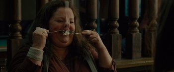 Movie still from “The Heat” (2013), directed by Paul Feig – A woman holding a fork up to her mouth; Close Up shot, Over the shoulder angle