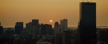 Movie still from “The Heat” (2013), directed by Paul Feig – The sun is setting over a city skyline; Extreme Wide shot, High angle