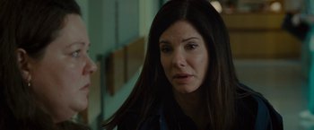 Movie still from “The Heat” (2013), directed by Paul Feig – A person with long black hair; Close Up shot, Over the shoulder angle