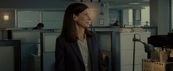 Movie still from “The Heat” (2013), directed by Paul Feig – A woman in a suit and a jacket; Medium shot, Over the shoulder angle