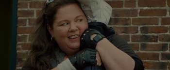 Movie still from “The Heat” (2013), directed by Paul Feig – A woman in black leather gloves holding onto a man in black leather gloves; Close Up shot, Over the shoulder angle