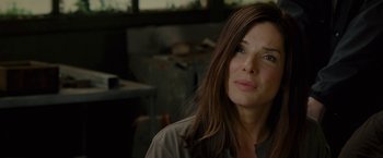 Movie still from “The Heat” (2013), directed by Paul Feig – A person with long brown hair; Close Up shot, Over the shoulder angle