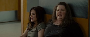 Movie still from “The Heat” (2013), directed by Paul Feig – Two women sitting next to each other in a room; Close Up shot, Low angle