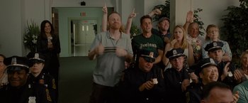 Movie still from “The Heat” (2013), directed by Paul Feig – A group of people standing in front of a building; Medium shot, Low angle