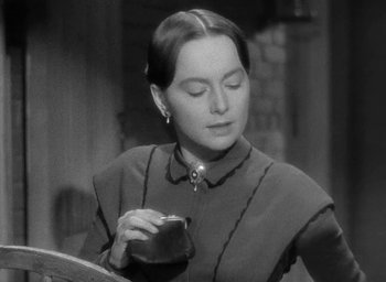 Movie still from “The Heiress” (1949), directed by William Wyler – An old photo of a woman looking at her cell phone; Close Up shot, Over the shoulder angle
