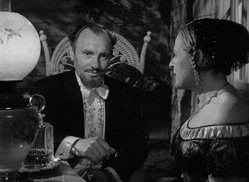 Movie still from “The Heiress” (1949), directed by William Wyler – A man and a woman sitting at a dinner table; Medium shot, Over the shoulder angle