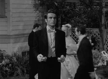 Movie still from “The Heiress” (1949), directed by William Wyler – A black and white photo of a man in a tuxedo; Medium shot, Over the shoulder angle