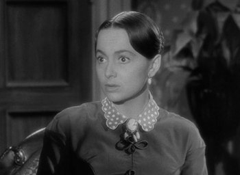Movie still from “The Heiress” (1949), directed by William Wyler – A black - and - white photo of a woman in a polka dot shirt; Close Up shot, Over the shoulder angle