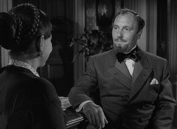 Movie still from “The Heiress” (1949), directed by William Wyler – A man and a woman are sitting at a table; Close Up shot, Over the shoulder angle
