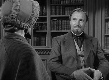 Movie still from “The Heiress” (1949), directed by William Wyler – A man and a woman are talking in front of a bookcase; Close Up shot, Over the shoulder angle