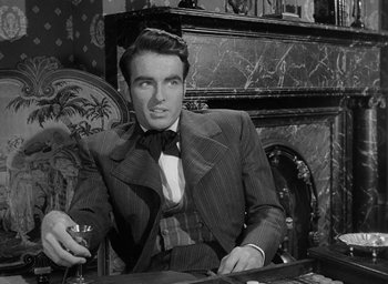 Movie still from “The Heiress” (1949), directed by William Wyler – A black and white photo of a man sitting at a table; Medium shot, Low angle