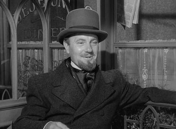 Movie still from “The Heiress” (1949), directed by William Wyler – A man wearing a top hat and a suit and tie; Medium shot, Over the shoulder angle