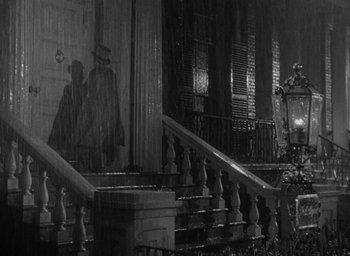 Movie still from “The Heiress” (1949), directed by William Wyler – A black - and - white photo of a building with a staircase; Wide shot, Low angle