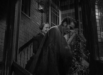 Movie still from “The Heiress” (1949), directed by William Wyler – A man and a woman walking down the stairs of a house; Medium shot, Low angle