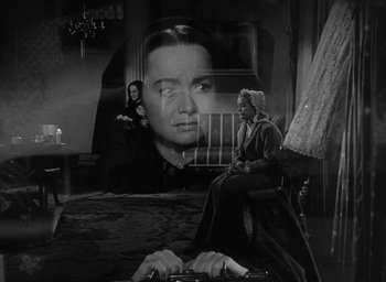 Movie still from “The Heiress” (1949), directed by William Wyler – A woman sitting in front of a large picture of a woman; Medium shot, Over the shoulder angle