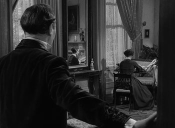 Movie still from “The Heiress” (1949), directed by William Wyler – A man and a woman are watching television; Medium shot, Over the shoulder angle