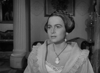 Movie still from “The Heiress” (1949), directed by William Wyler – An old photo of a woman in a dress; Close Up shot, Over the shoulder angle