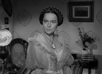 Movie still from “The Heiress” (1949), directed by William Wyler – A black and white photo of a woman in a dress; Close Up shot, Over the shoulder angle