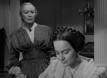 Movie still from “The Heiress” (1949), directed by William Wyler – Two women in old - fashioned dresses looking at each other; Close Up shot, Over the shoulder angle