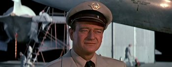 Movie still from “The High and the Mighty” (1954), directed by William A. Wellman – A person wearing a uniform; Close Up shot, Low angle