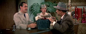 Movie still from “The High and the Mighty” (1954), directed by William A. Wellman – A group of people sitting around a table; Medium shot, High angle