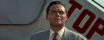 Movie still from “The High and the Mighty” (1954), directed by William A. Wellman – A man in a suit and a tie; Close Up shot, Low angle