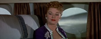 Movie still from “The High and the Mighty” (1954), directed by William A. Wellman – A person wearing a suit and tie; Close Up shot, Low angle