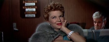 Movie still from “The High and the Mighty” (1954), directed by William A. Wellman – A person wearing a fur coat; Close Up shot, Low angle