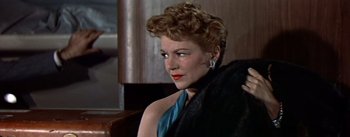 Movie still from “The High and the Mighty” (1954), directed by William A. Wellman – A person wearing a dress; Close Up shot, Low angle